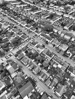 Black and white aerial view of suburban streets and houses in Hertfordshire, England.
