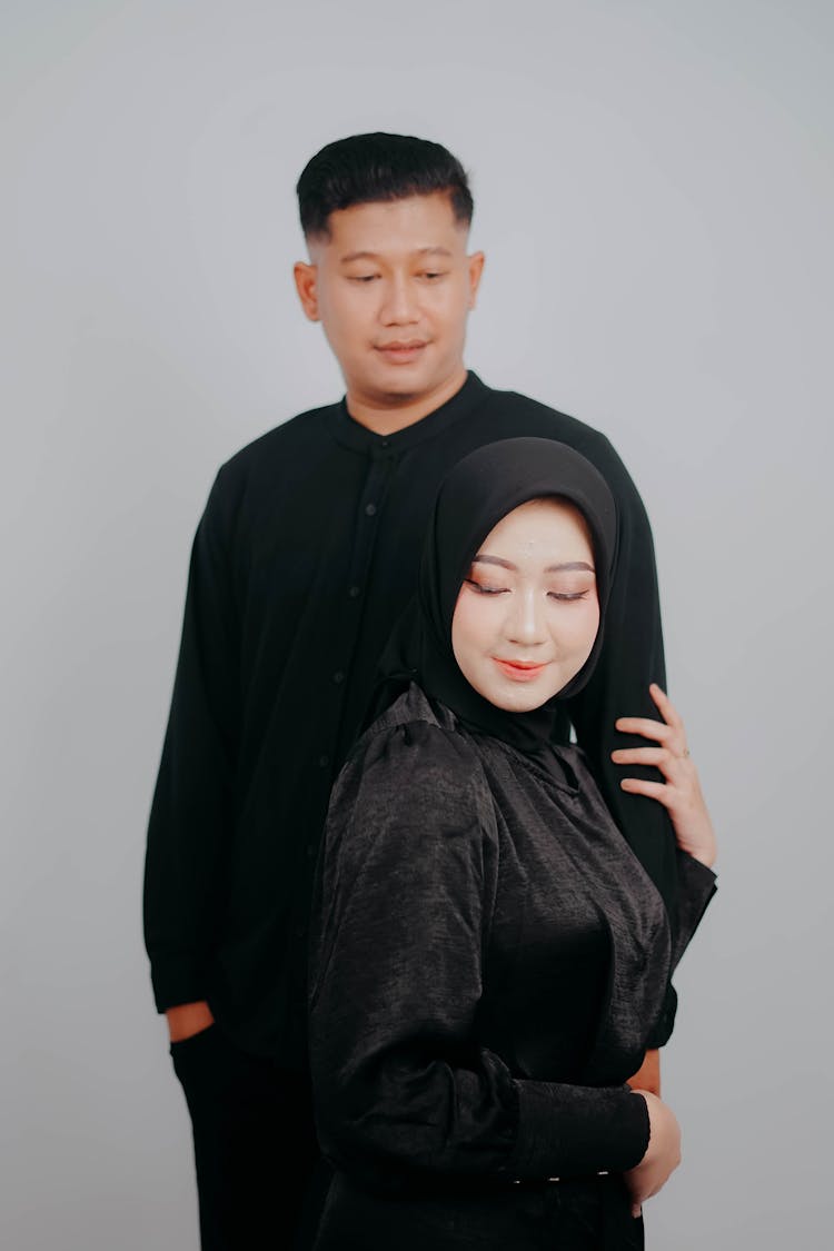 Portrait Of Man And Woman In Hijab