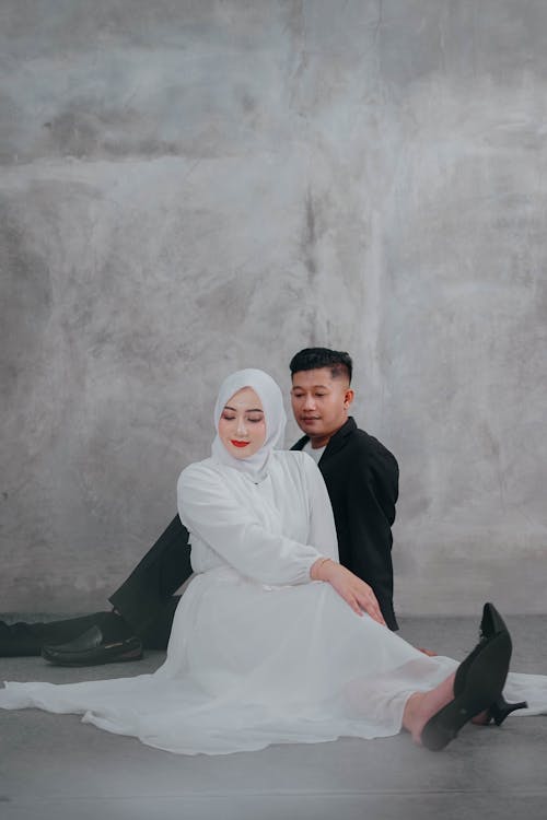 Couple Sitting and Posing for their Wedding Photoshoot