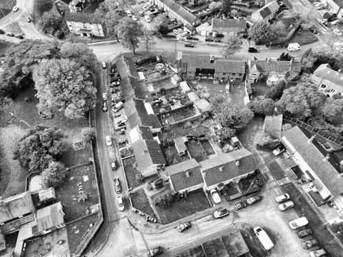 Free Aerial black and white capture of Hertfordshire townscape highlighting rooftops and streets from above. Stock Photo