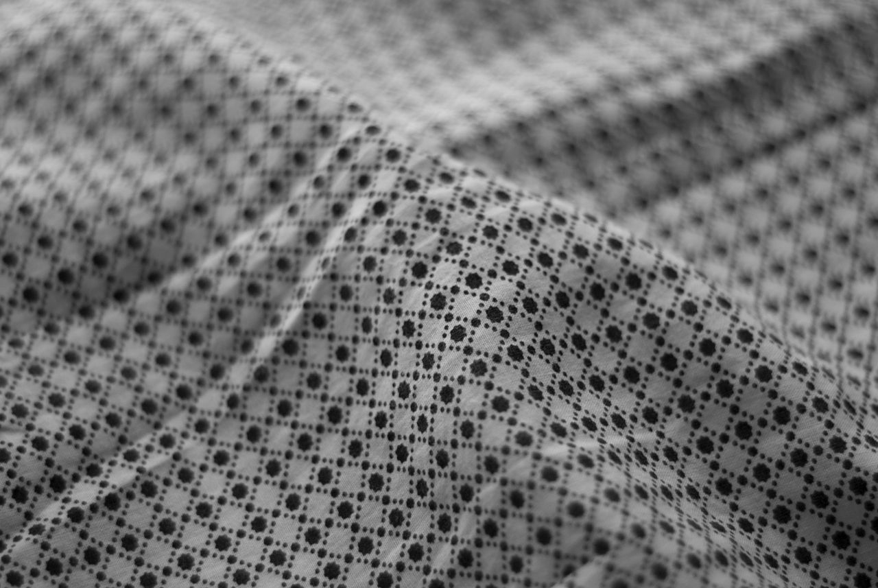 close up of a geometric pattern on fabric in black and white perfect f