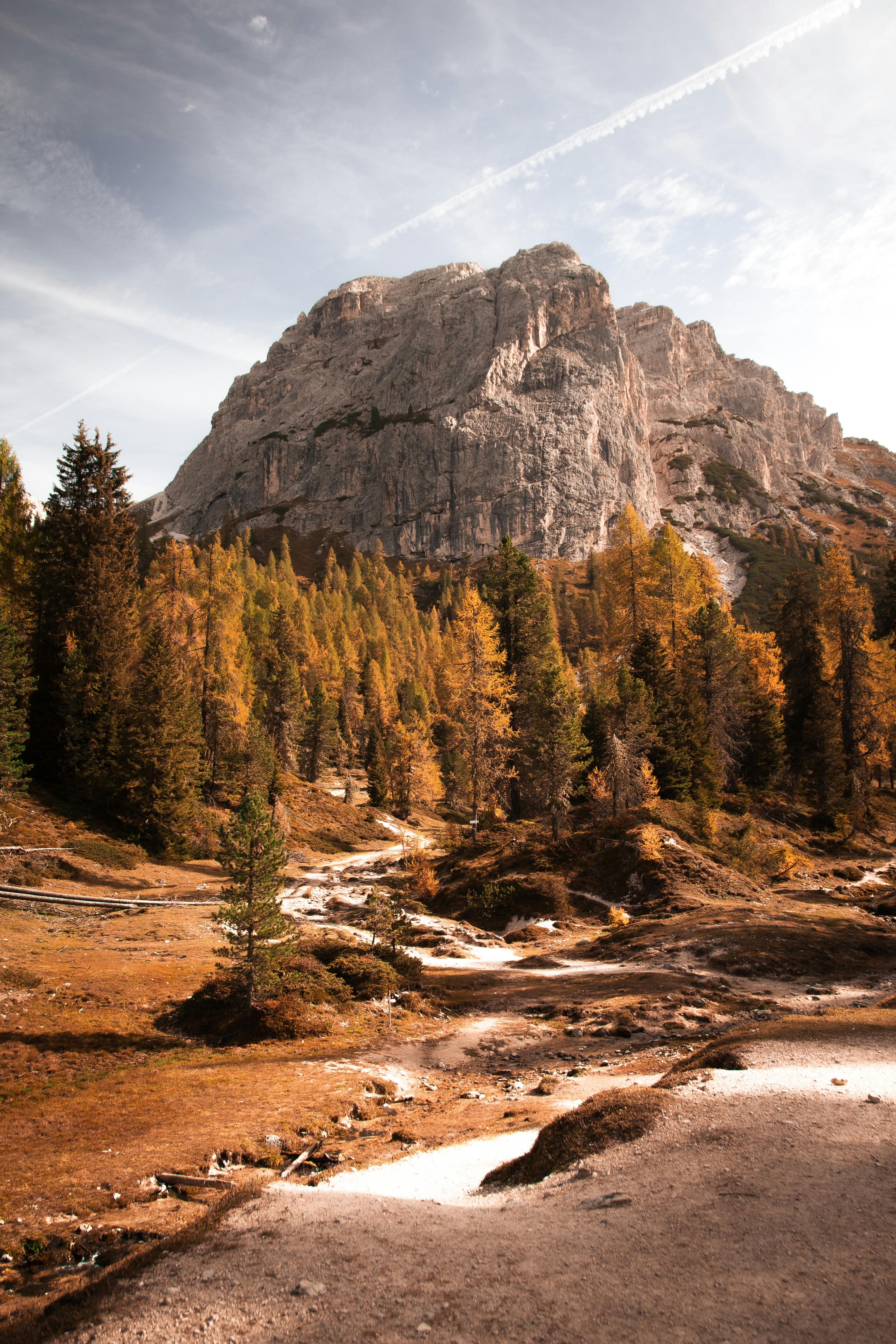 Captivating autumn view of Ortisei's alpine landscape with majestic mountains and vibrant fall colors.