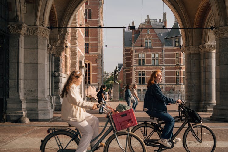 Women On Bicycles On The Streets Of Amsterdam, The Netherlands 