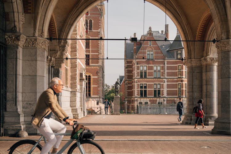 Man On A Bicycle On The Streets Of Amsterdam, The Netherlands 