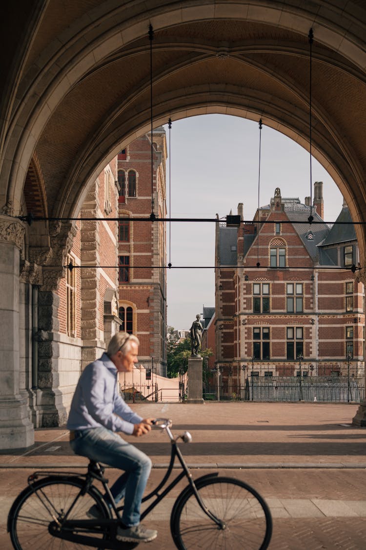 Man On A Bicycle On The Streets Of Amsterdam, The Netherlands 