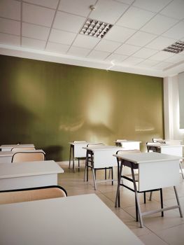Modern classroom interior with desks and chairs, showcasing clean design and ample natural light.