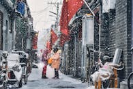 白雪皑皑的小巷里，两个人挂着红旗，捕捉到了冬日的宁静时刻