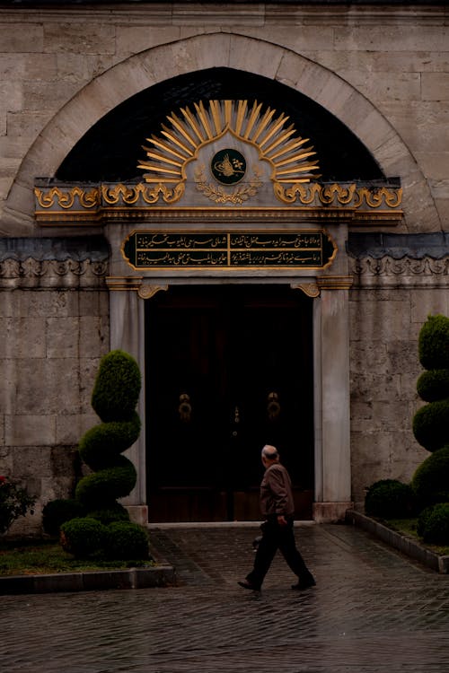 Man Walking in front of an Ottoman Building in Istanbul, Turkey 
