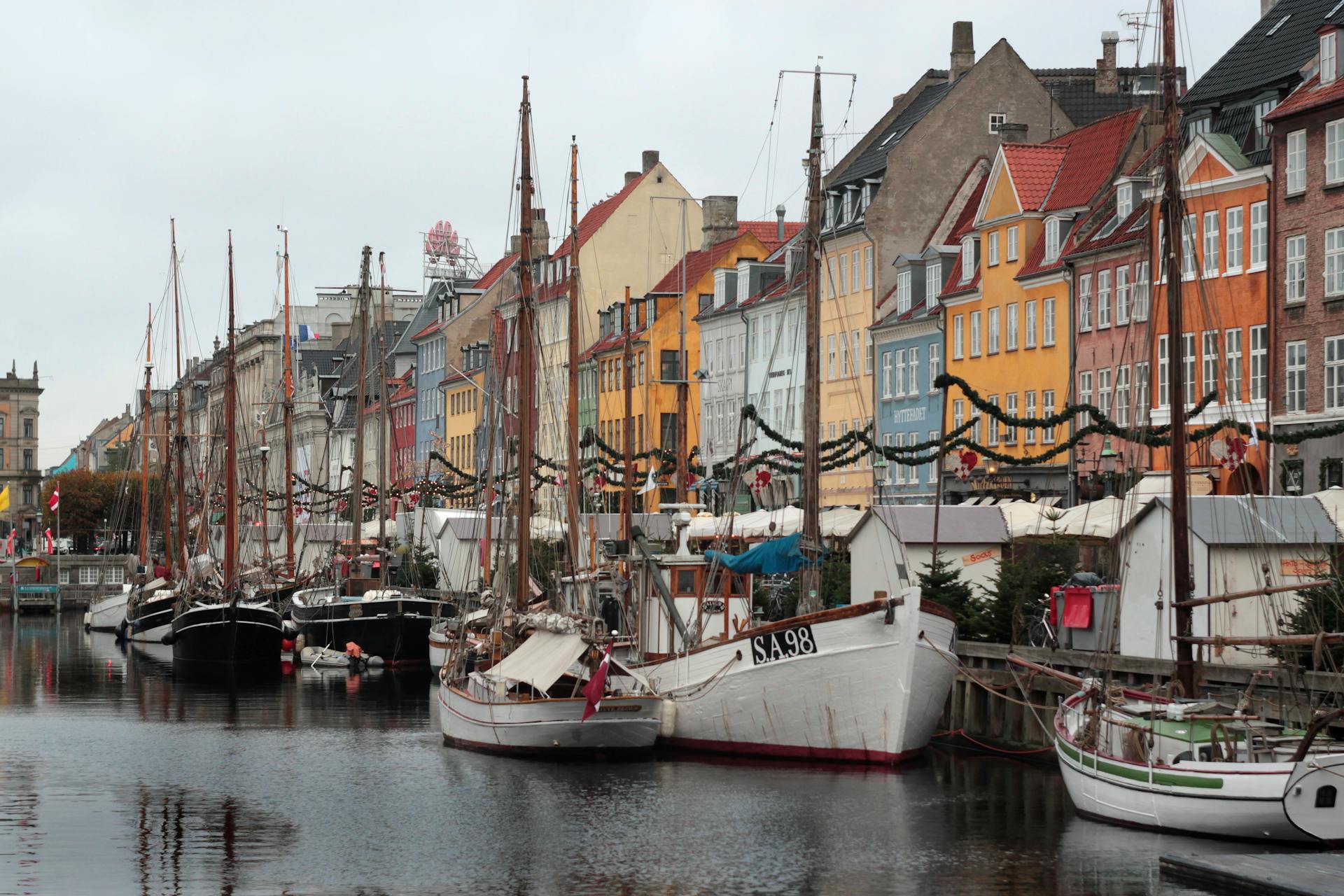 View of Boats Moored in the Port and Colorful Houses in Nyhavn, Copenhagen, Denmark