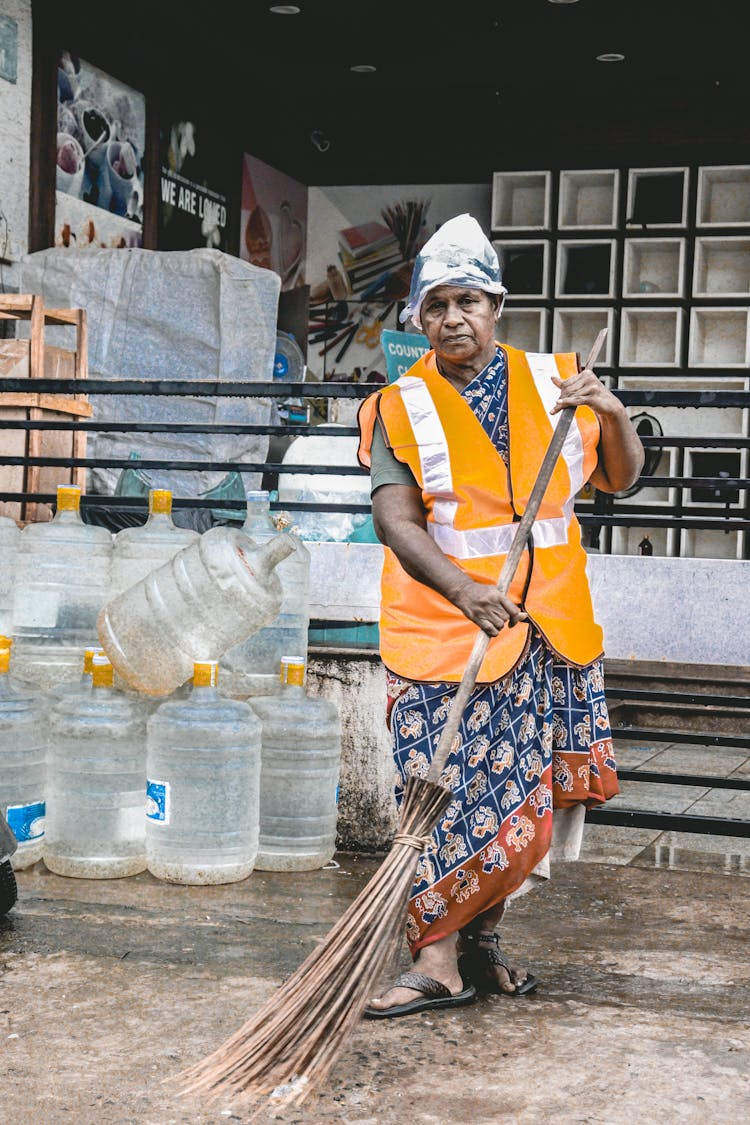 Elderly Woman Sweeping The Floor 