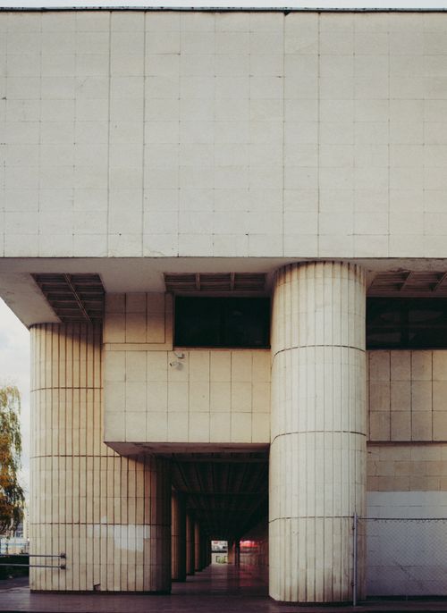 Free A minimalist view of modern urban architecture featuring large concrete columns and geometric design. Stock Photo