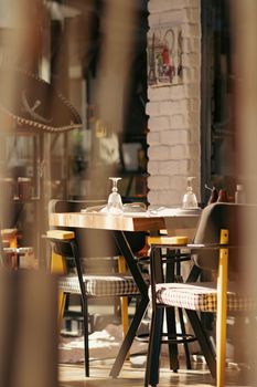 Warm and inviting restaurant interior with an elegantly set table and soft lighting.