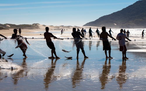 Fishermen Holding Net on Beach