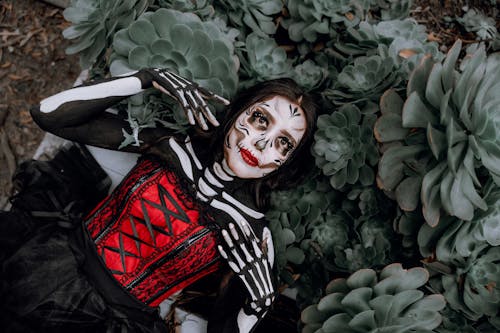 A Woman in a Skeleton Costume Lying on the Ground