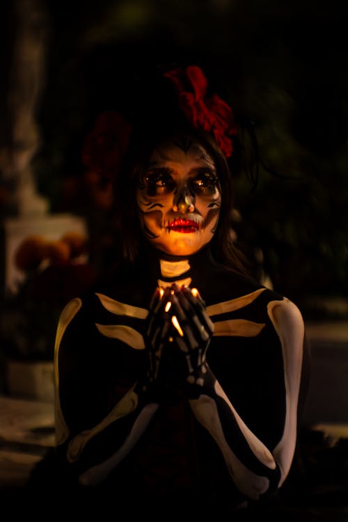 Woman in Skeleton Costume Holds Light in Hands