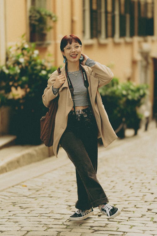 Smiling Woman in Jacket and with Bag Standing on Street