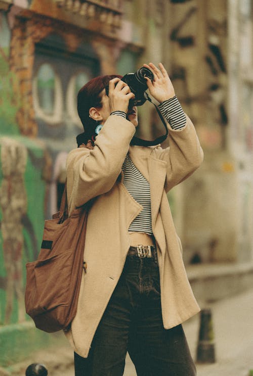 Young Woman Taking a Photo on a Street