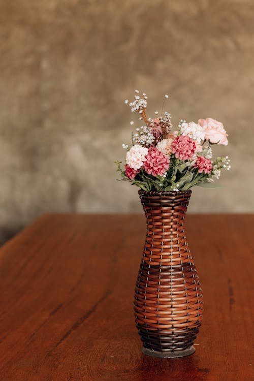 A Vase with Flowers on a Wooden Table 