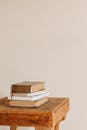 A Pile of Old Books Lying on a Wooden Stool