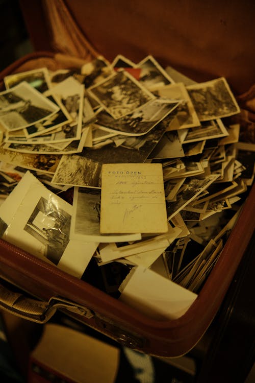 An Old Suitcase with Black and White Photos 