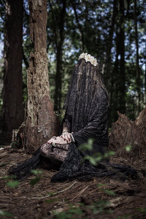 Woman Wearing Black Veil in a Forest