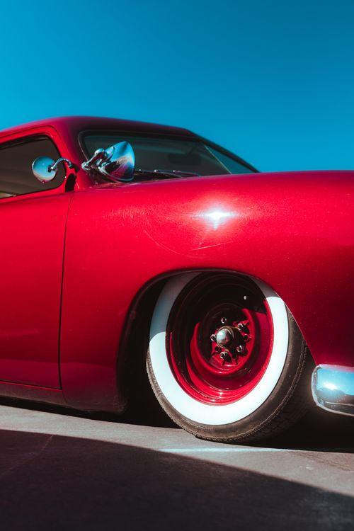 Free Striking close-up view of a vintage red car showcasing its vibrant paint and chrome detailing. Stock Photo