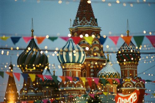 Free A vibrant view of St. Basil's Cathedral with festive flags and lights in Moscow, Russia. Stock Photo