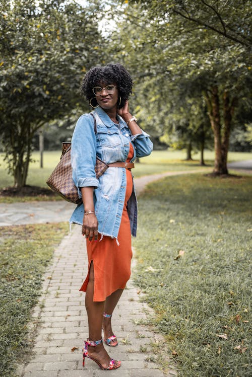 Model in Jean Jacket and with Bag in Park
