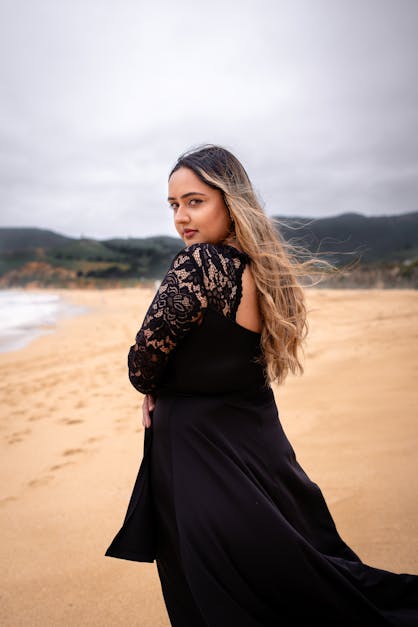Model in Black Dress on Beach · Free Stock Photo