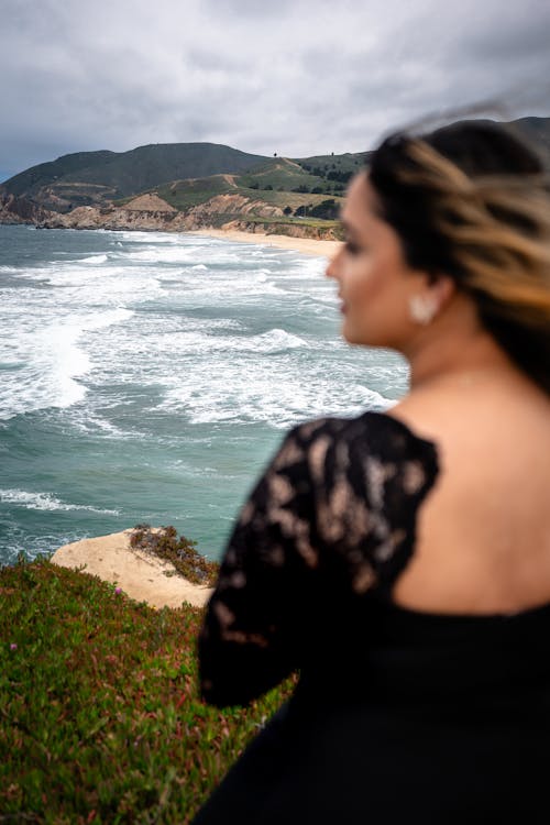 Waves on Sea Shore behind Model in Black Dress