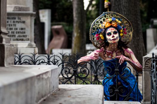 A woman dressed as a skeleton in a cemetery