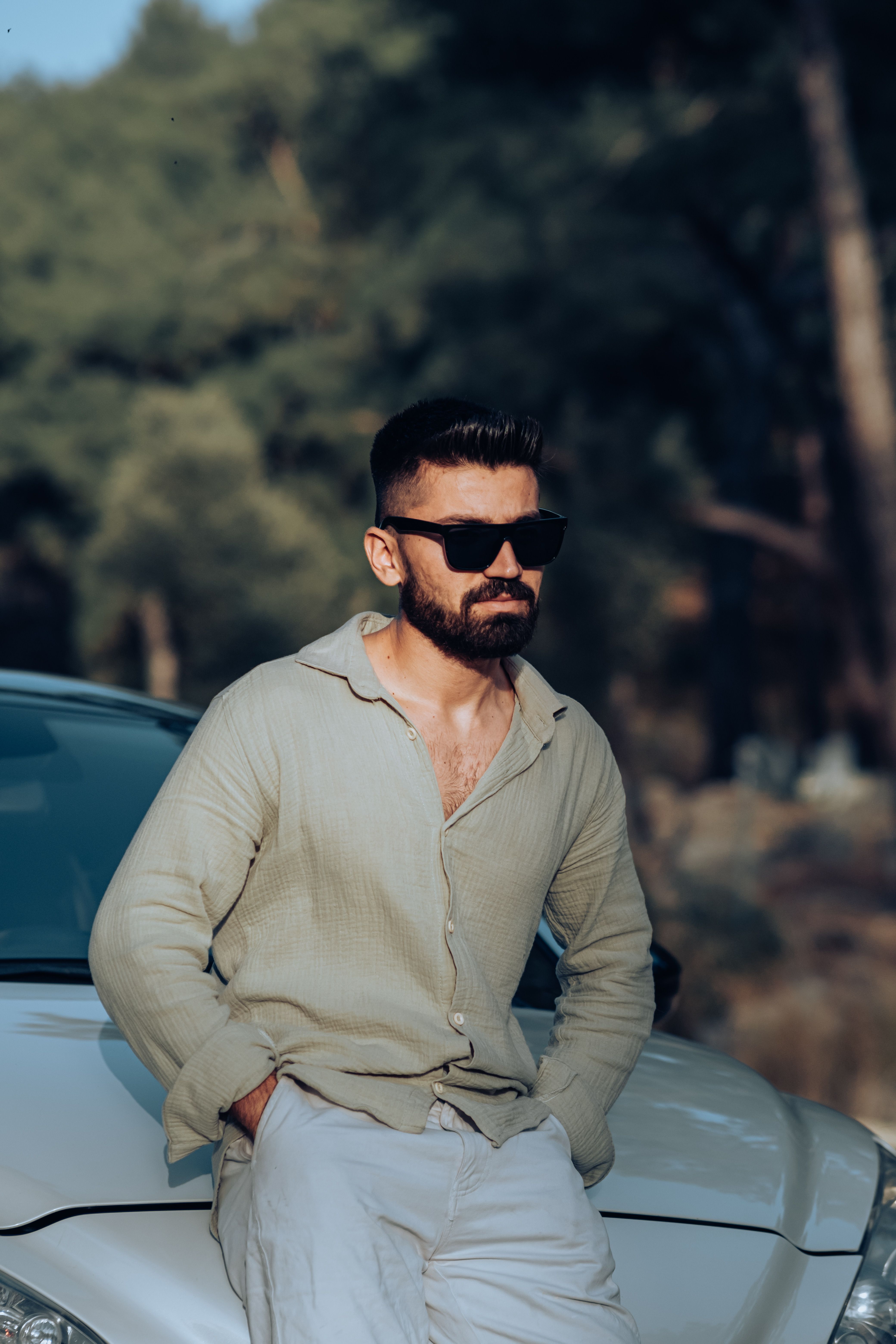 Man in Sunglasses Sitting on the Hood of a Car · Free Stock Photo