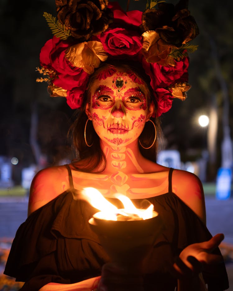 Portrait Of Woman Wearing Traditional Costume Holding A Flame 