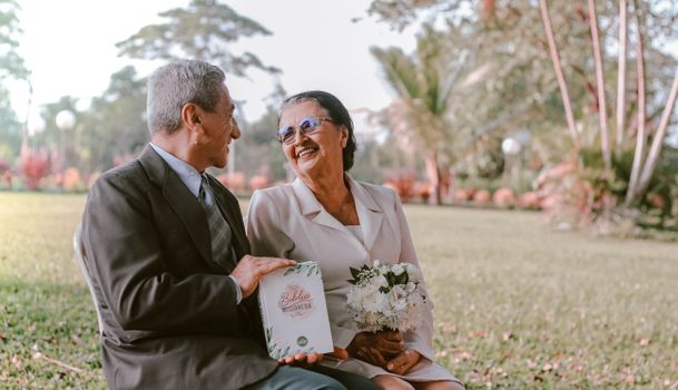 Elderly Couple with Missionary Bible in the Park