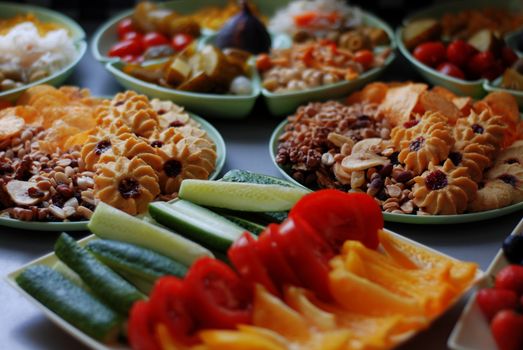 A close-up of mixed sweet cookies and fresh vegetables on a table for a delicious treat.