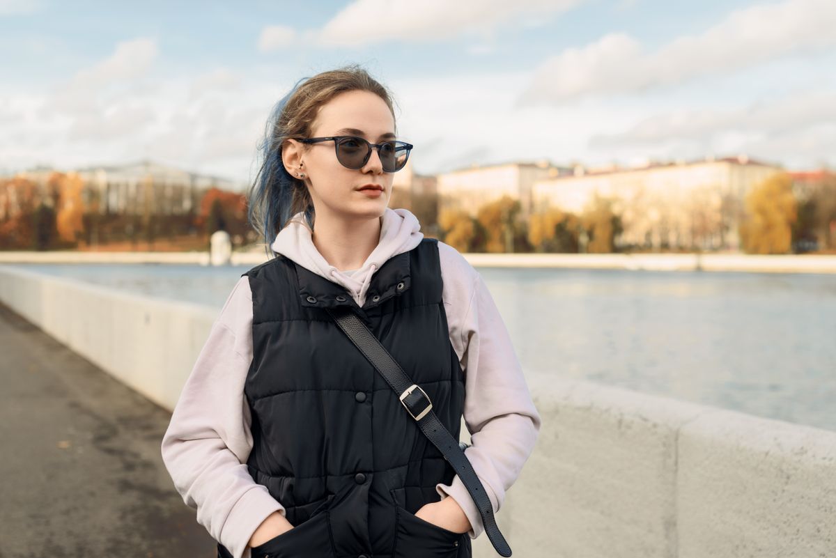 woman wearing a casual vest outfit styled with sunglasses for fall
