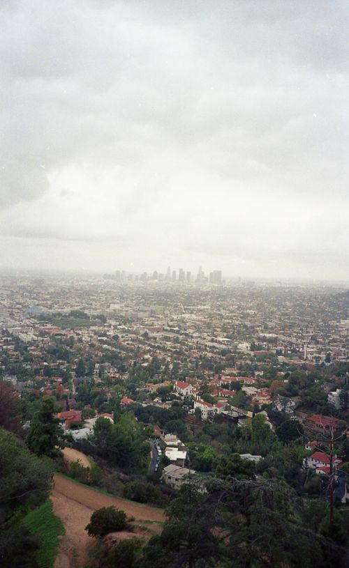 Free Aerial perspective of Los Angeles cityscape under cloudy skies, showcasing urban sprawl and skyline. Stock Photo