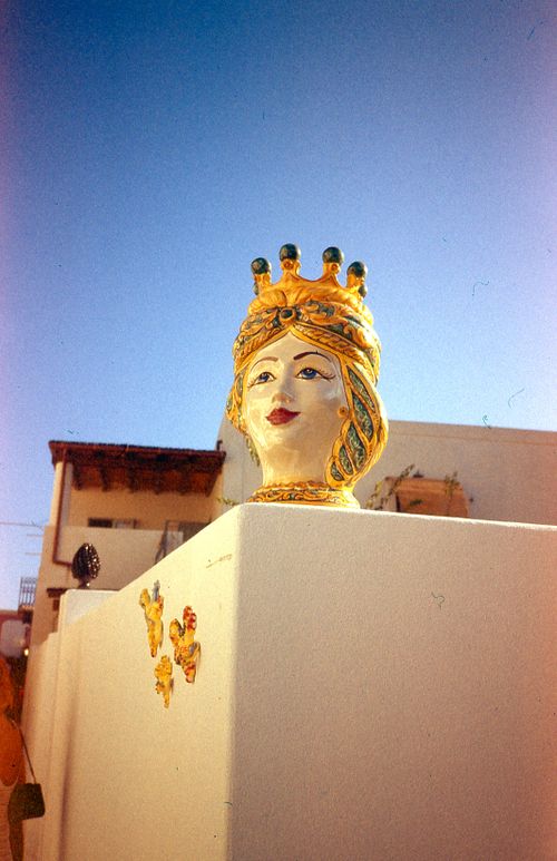 Free Vibrant ceramic sculpture on a wall in Stromboli, Sicily under a clear blue sky. Stock Photo