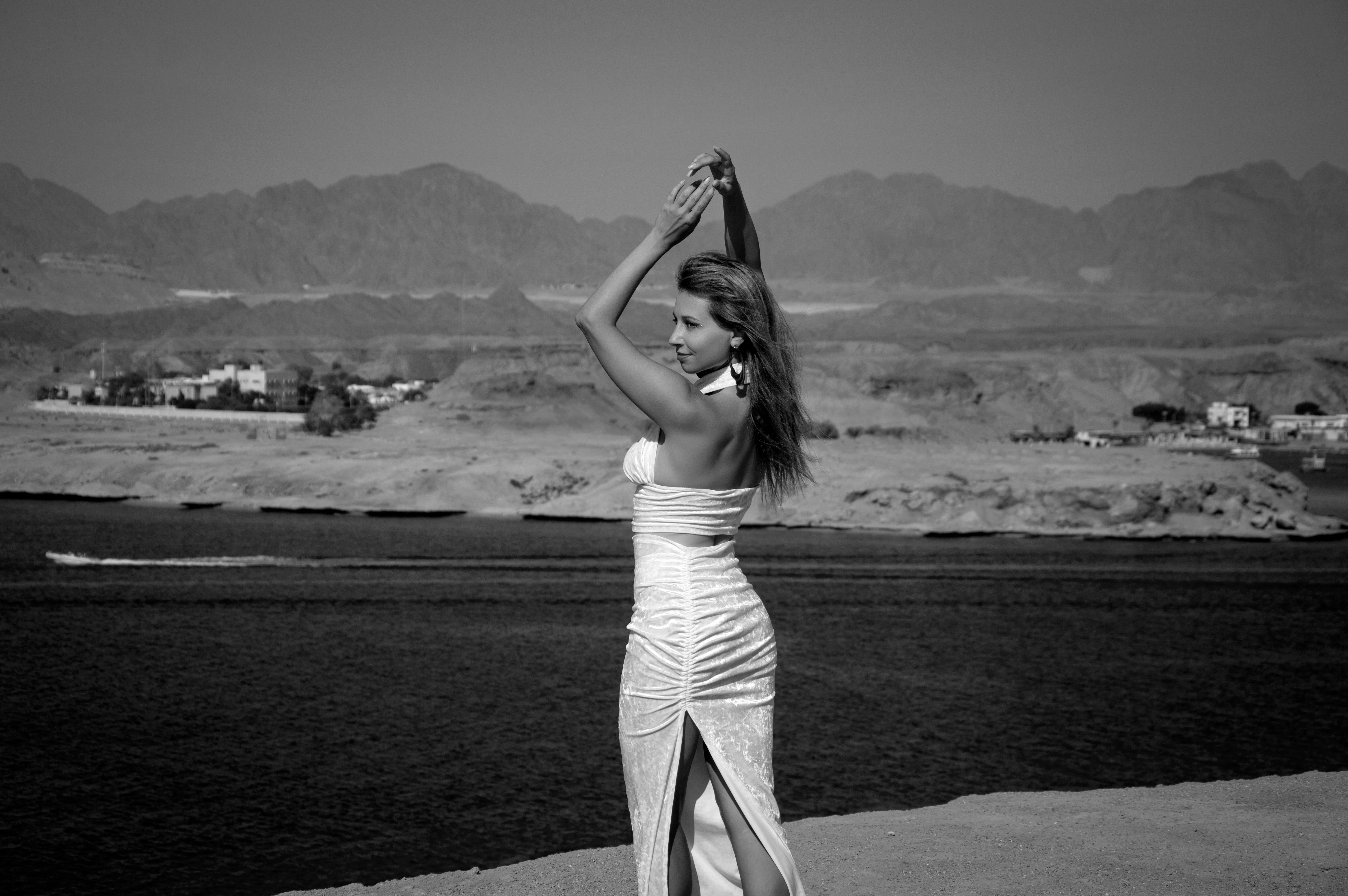 Black and White Photo of Topless Woman Sitting on Beach · Free Stock Photo