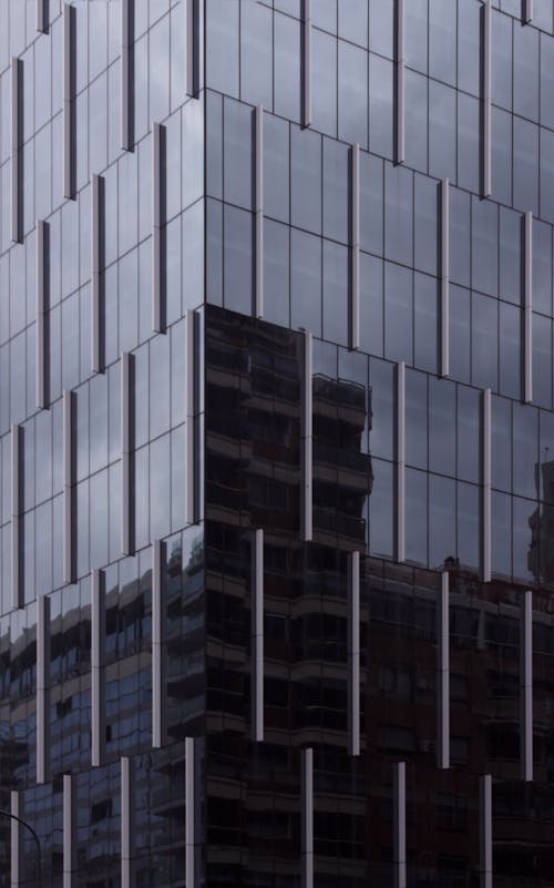 Glass Facade of a Skyscraper Reflecting the Opposite Buildings 