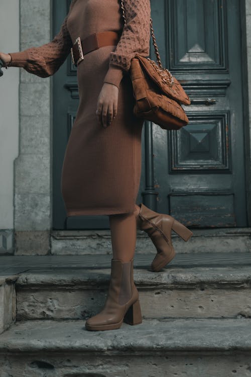 Woman in Boots and with Bag on Stairs