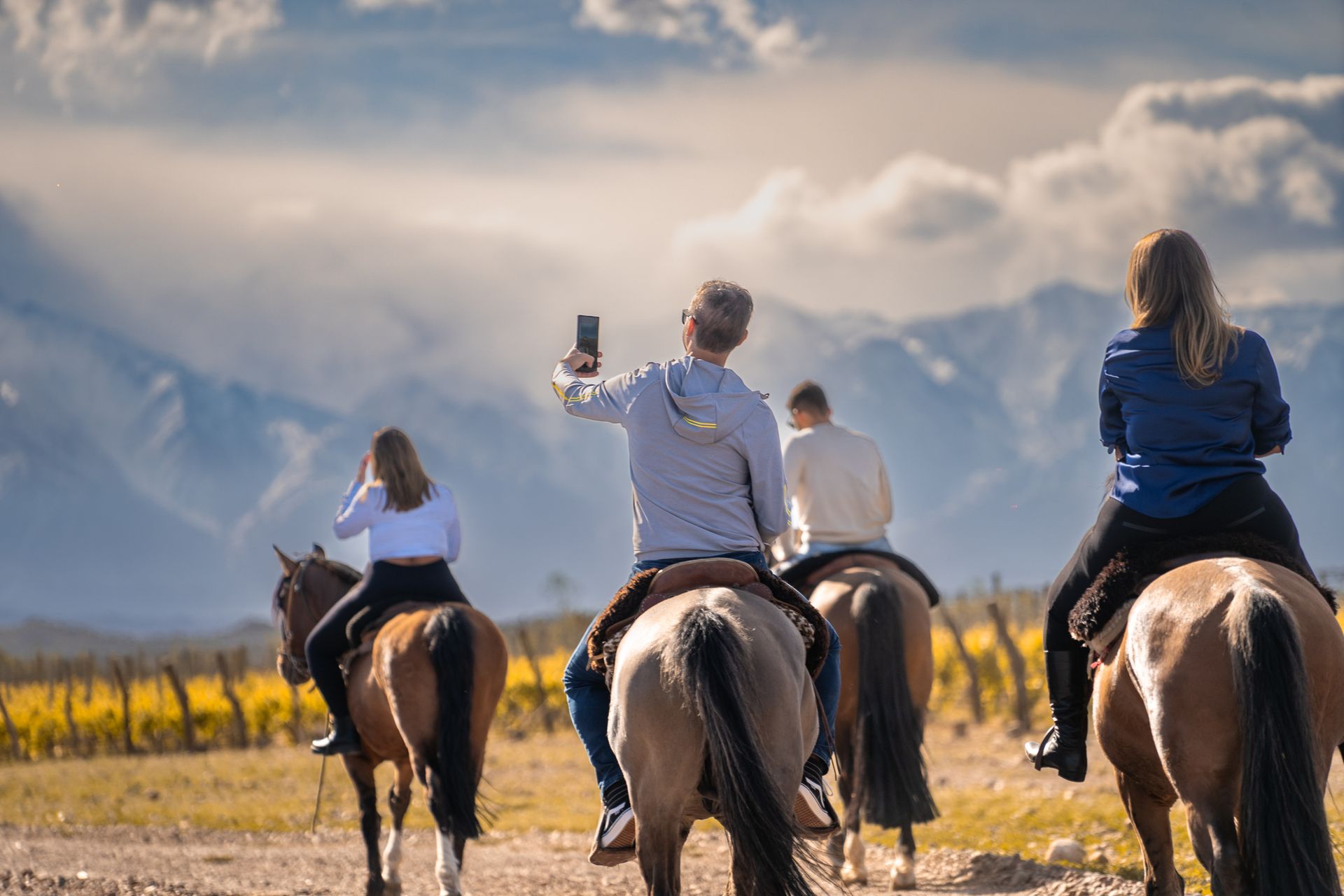 Four People Riding on Horses