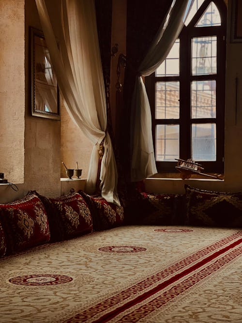 Interior of a Room with Pillows and Rugs in Traditional Patterns 
