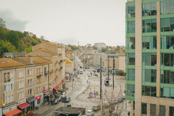 Busy street view of Poitiers, France, showcasing modern and classic architecture