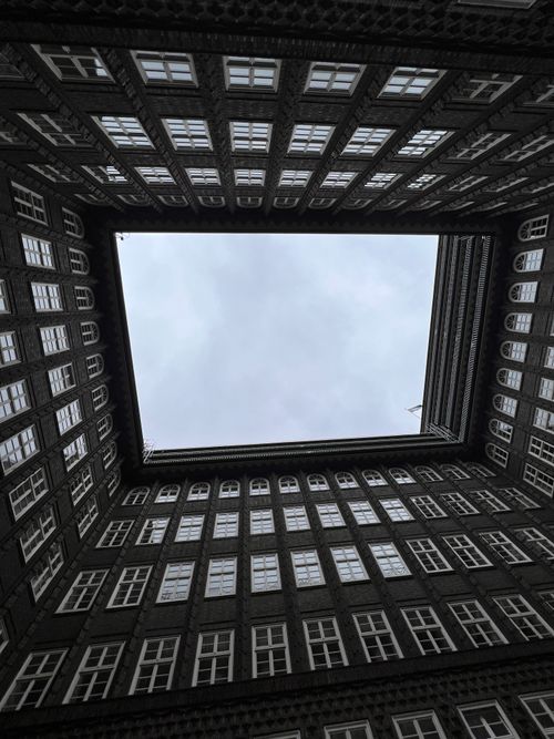Free Upward view of the iconic Chile House courtyard's architectural beauty in Hamburg, Germany. Stock Photo