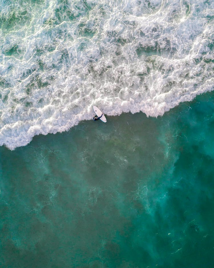 Person Riding Surfboard