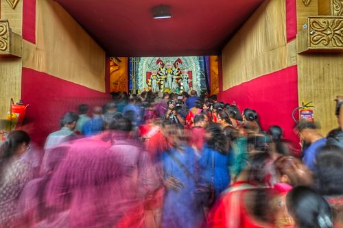 Free Crowds gather to celebrate a vibrant cultural festival in Kolkata, India, featuring traditional performances and worship. Stock Photo