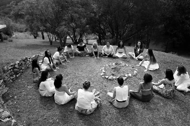 Women Sitting In Circle Around Fire Pit