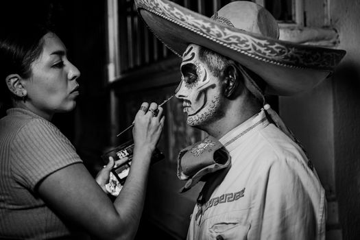 Artistic capture of face painting for Day of the Dead celebration with intricate details.