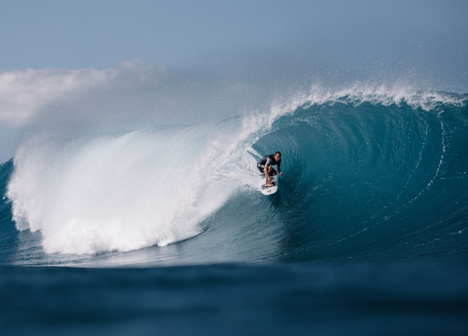 Surfer riding a large ocean wave